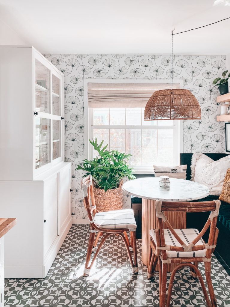 dining nook with floral wallpaper and hanging light and floating shelves