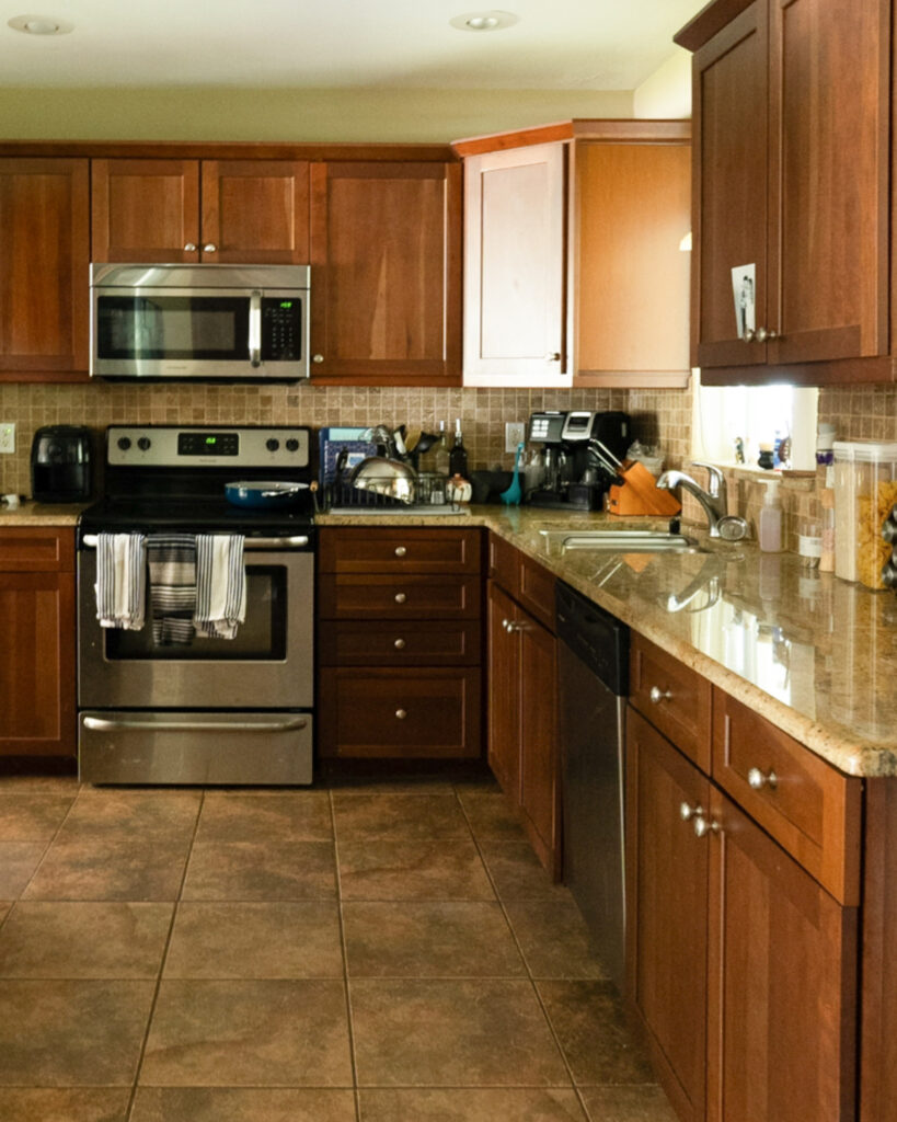 brown kitchen cabinets with appliances